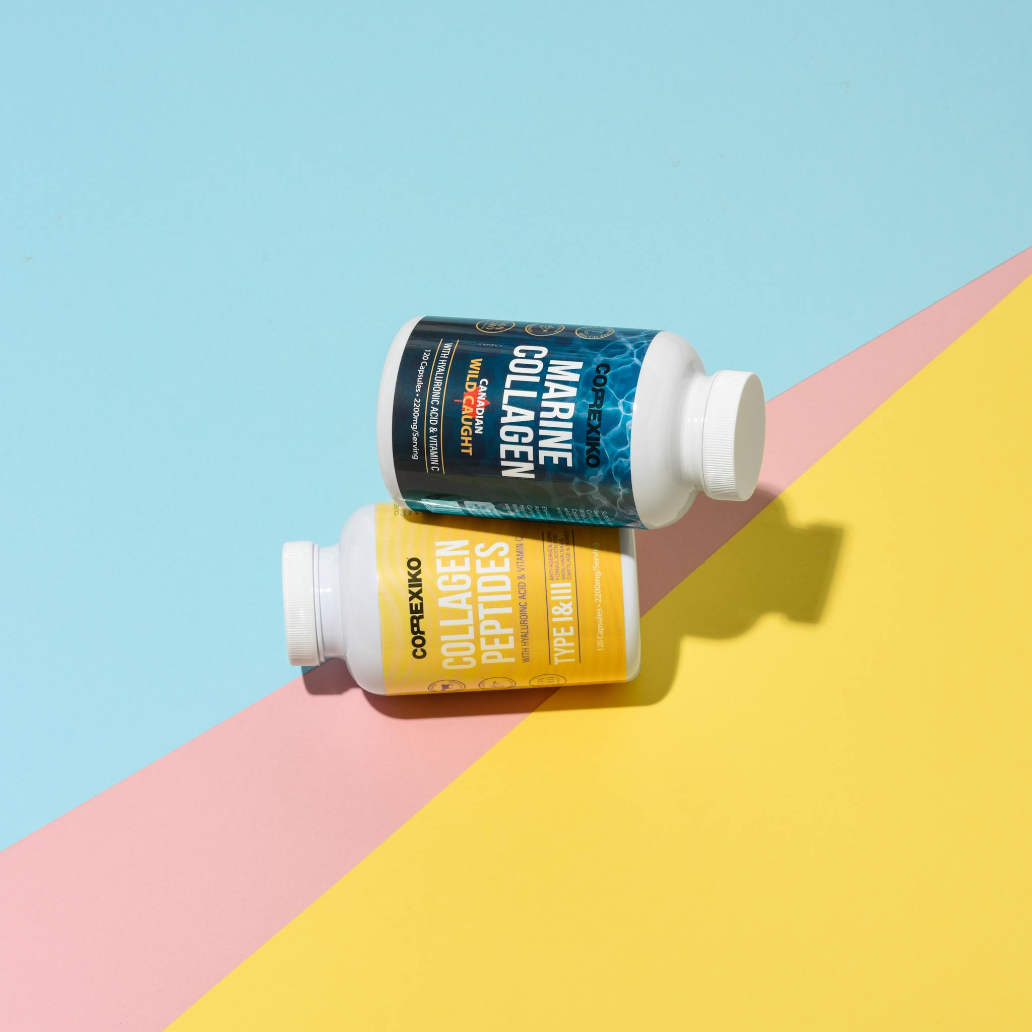 Top-down view of collagen supplement bottles on a pastel background, showcasing product design.
